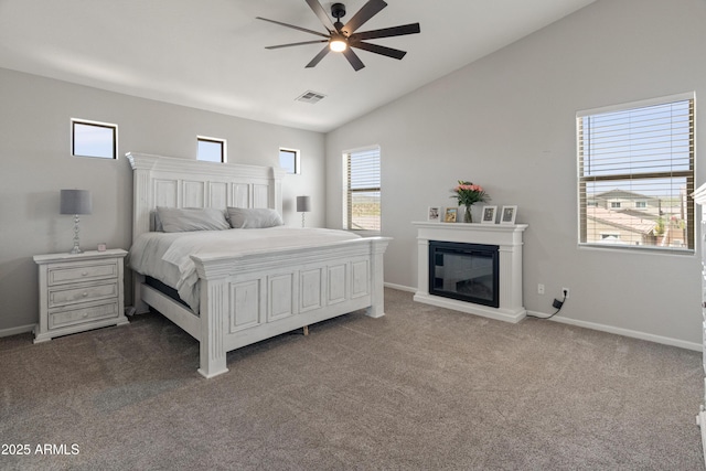 4418 W Yoosooni Dr, New River, AZ 85087 - bedroom with vaulted ceiling, carpet, a glass covered fireplace, and ceiling fan