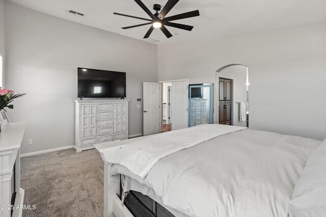 4418 W Yoosooni Dr, New River, AZ 85087 - bedroom with light colored carpet, arched walkways, ceiling fan, and lofted ceiling