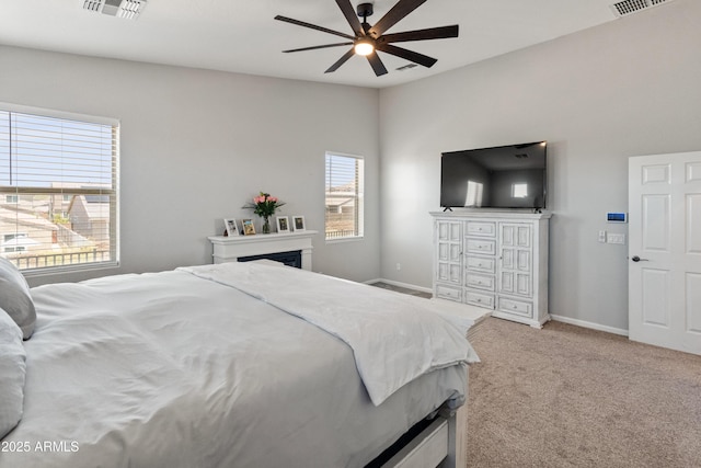 4418 W Yoosooni Dr, New River, AZ 85087 - bedroom featuring light colored carpet, a fireplace, and ceiling fan