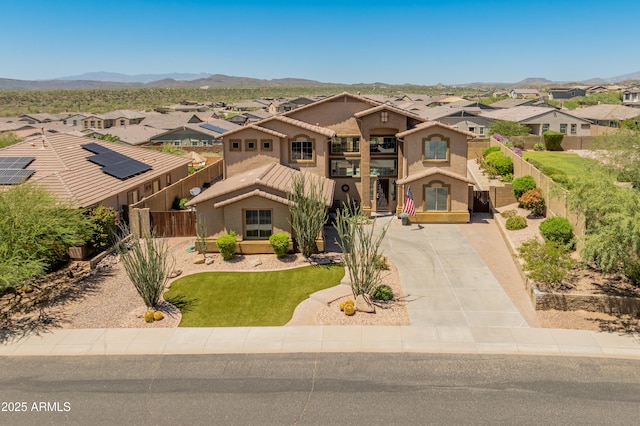 4418 W Yoosooni Dr, New River, AZ 85087 - mediterranean / spanish-style home featuring a residential view, driveway, stucco siding, a mountain view, and a balcony