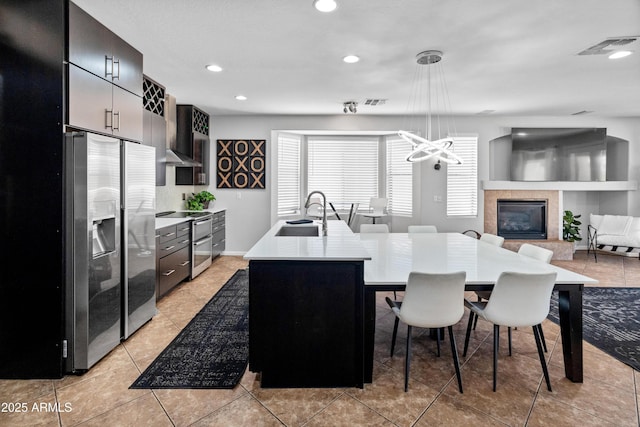 4418 W Yoosooni Dr, New River, AZ 85087 - kitchen featuring stainless steel appliances, light countertops, a kitchen breakfast bar, recessed lighting, and an island with sink