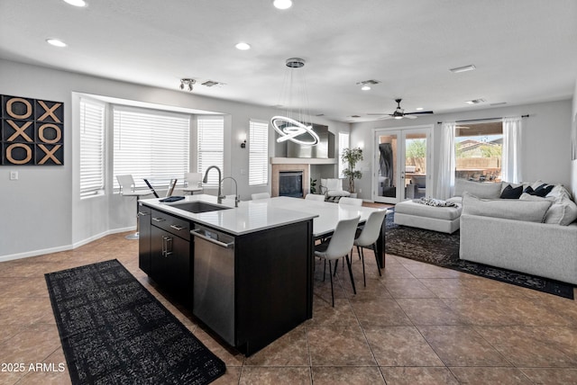 4418 W Yoosooni Dr, New River, AZ 85087 - kitchen with open floor plan, recessed lighting, stainless steel dishwasher, an island with sink, and pendant lighting