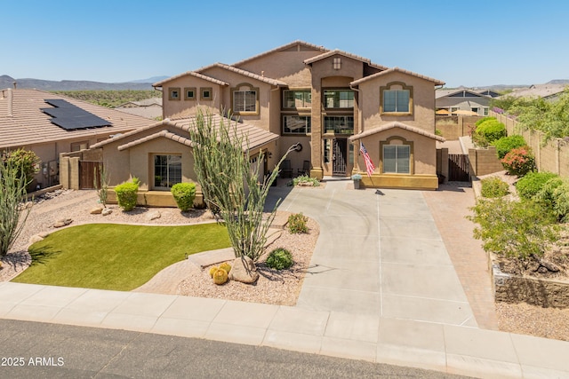4418 W Yoosooni Dr, New River, AZ 85087 - mediterranean / spanish home with stucco siding, concrete driveway, a gate, and a tiled roof