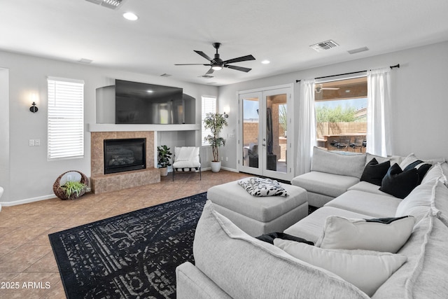 4418 W Yoosooni Dr, New River, AZ 85087 - tiled living room with plenty of natural light, a ceiling fan, a tiled fireplace, and recessed lighting