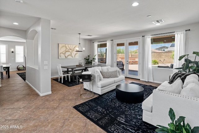 4418 W Yoosooni Dr, New River, AZ 85087 - living room featuring arched walkways, a chandelier, tile patterned flooring, and recessed lighting