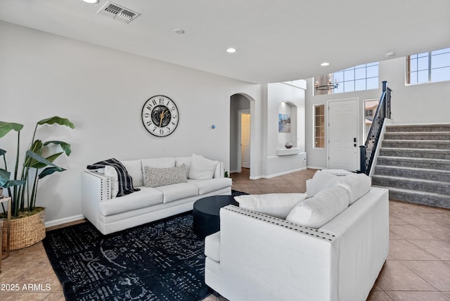 4418 W Yoosooni Dr, New River, AZ 85087 - living room featuring arched walkways, stairs, tile patterned floors, a chandelier, and recessed lighting