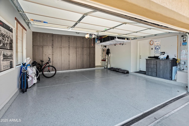 4418 W Yoosooni Dr, New River, AZ 85087 - garage featuring a garage door opener and water heater