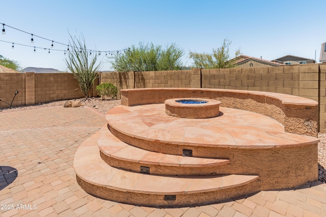 4418 W Yoosooni Dr, New River, AZ 85087 - fenced backyard with a patio and a fire pit