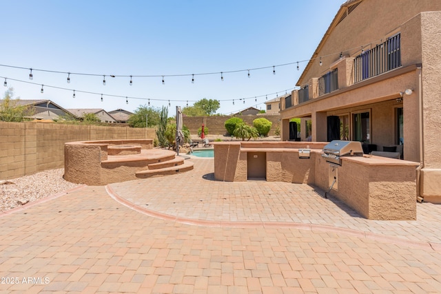 4418 W Yoosooni Dr, New River, AZ 85087 - fenced backyard with an outdoor kitchen and a patio