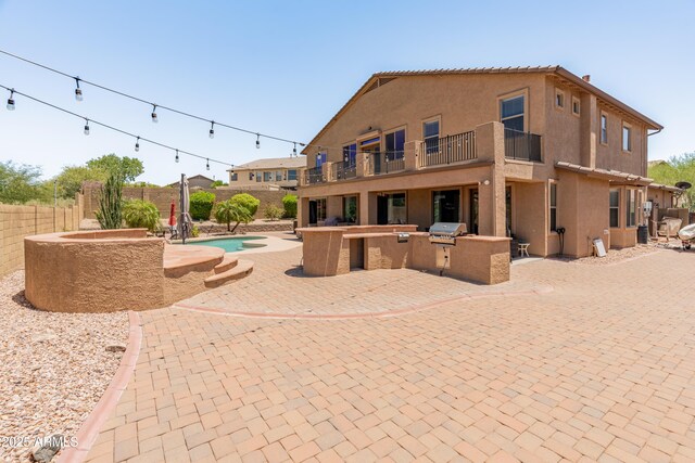 4418 W Yoosooni Dr, New River, AZ 85087 - back of house with area for grilling, a balcony, a fenced backyard, a patio, and stucco siding
