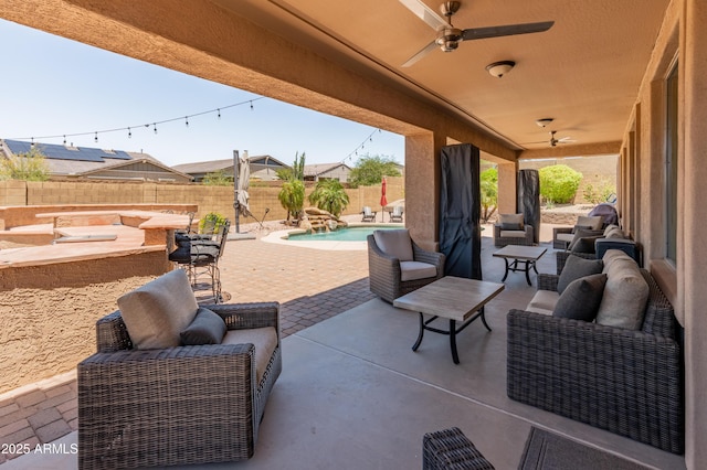 4418 W Yoosooni Dr, New River, AZ 85087 - fenced backyard with ceiling fan, a patio, and an outdoor hangout area