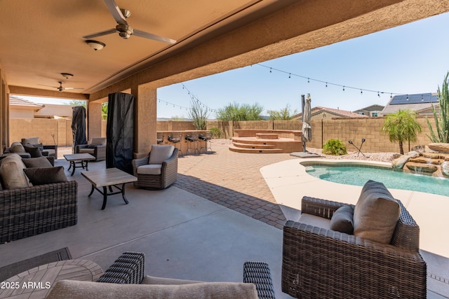 4418 W Yoosooni Dr, New River, AZ 85087 - fenced backyard featuring an outdoor hangout area, a patio area, and ceiling fan