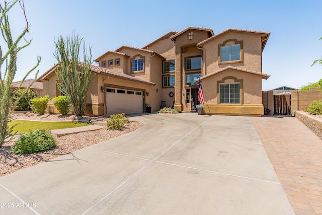 4418 W Yoosooni Dr, New River, AZ 85087 - mediterranean / spanish-style home with a gate, driveway, stucco siding, and a tile roof