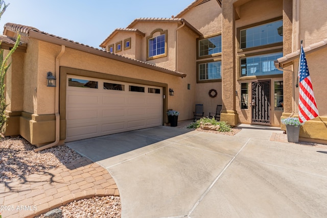 4418 W Yoosooni Dr, New River, AZ 85087 - view of front of property featuring concrete driveway, stucco siding, and a garage