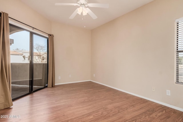 empty room with ceiling fan and light hardwood / wood-style flooring