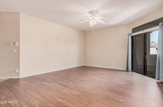 empty room with hardwood / wood-style floors and ceiling fan