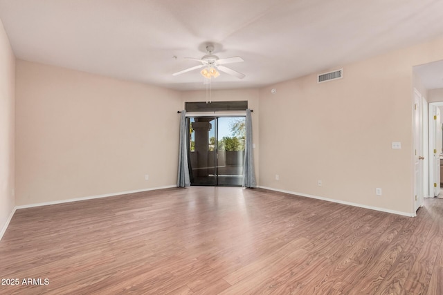 spare room featuring light hardwood / wood-style flooring and ceiling fan