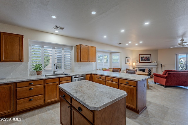 kitchen featuring a kitchen island, plenty of natural light, and sink