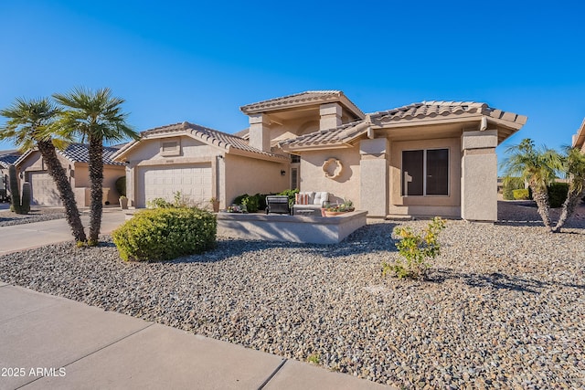 mediterranean / spanish-style house with a garage