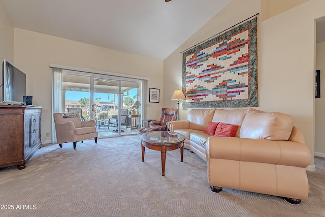 carpeted living room with ceiling fan and lofted ceiling