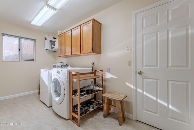 laundry area with cabinets and washing machine and clothes dryer