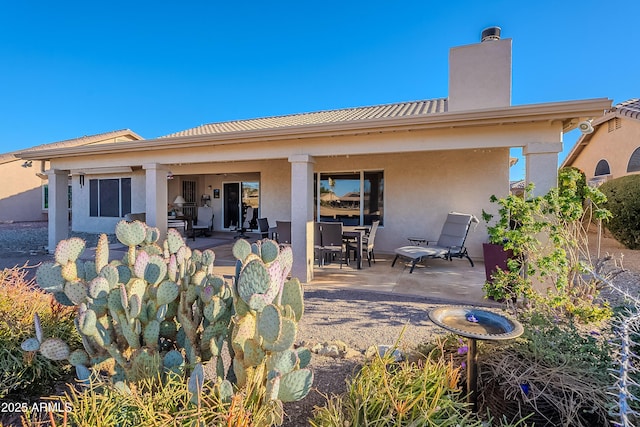 back of property with a patio