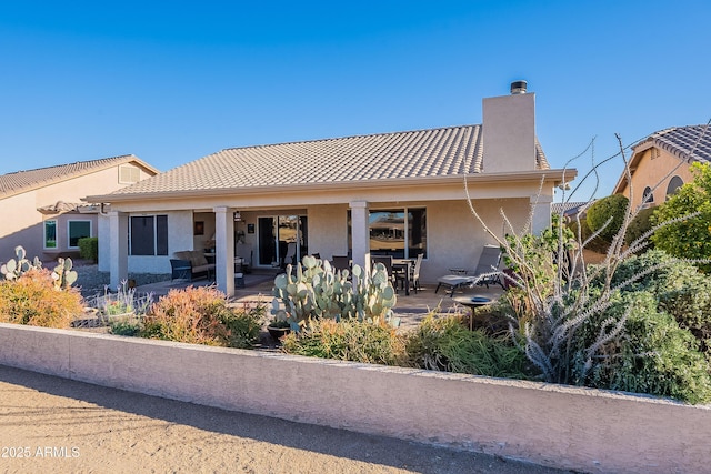 back of property featuring a patio area