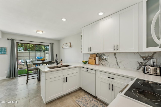 kitchen featuring dishwasher, a peninsula, decorative backsplash, white cabinetry, and recessed lighting