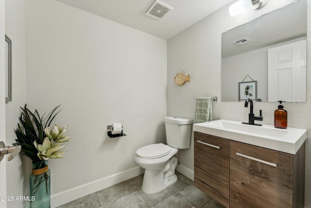 bathroom featuring toilet, baseboards, vanity, and tile patterned floors