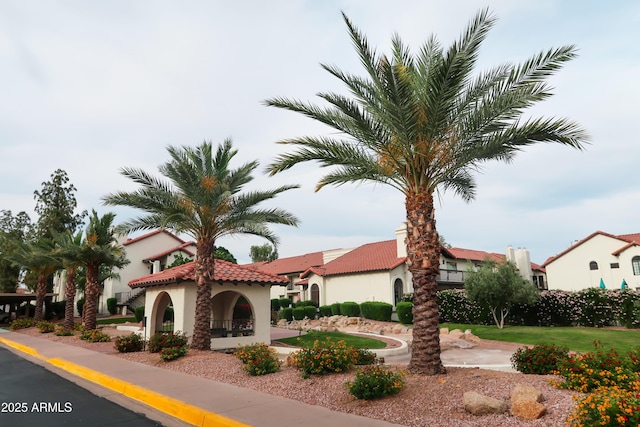 view of front of home featuring stucco siding and a tile roof