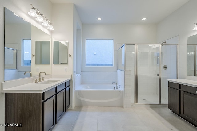 bathroom with plenty of natural light, plus walk in shower, tile patterned flooring, and vanity