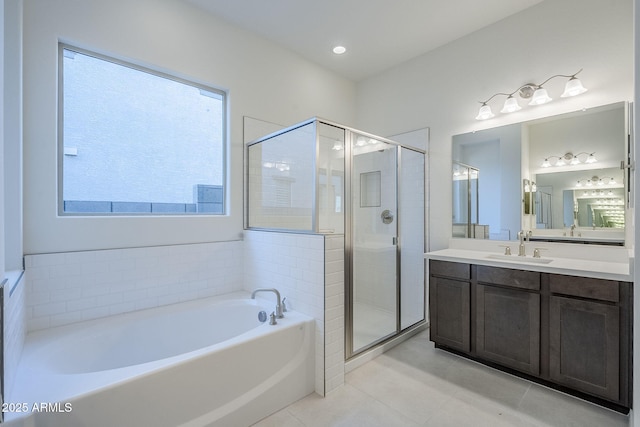 bathroom with vanity, tile patterned flooring, and plus walk in shower