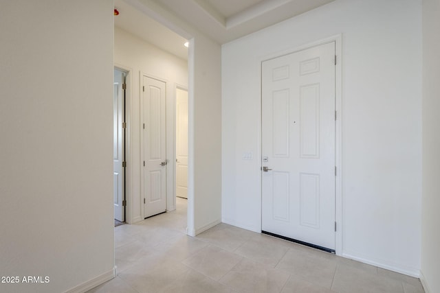 hallway featuring light tile patterned floors