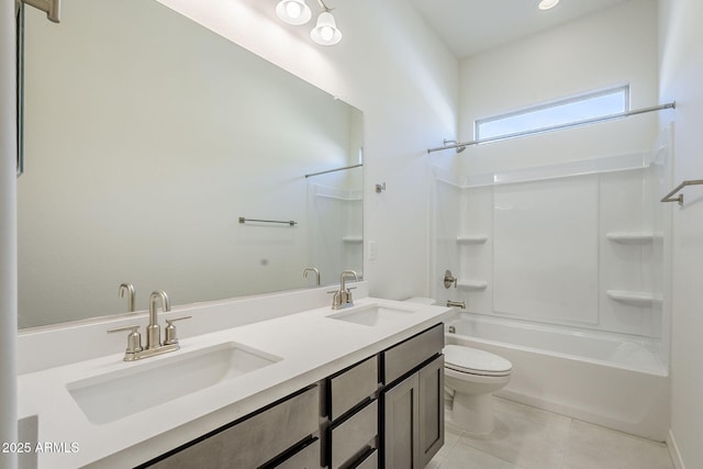 full bathroom with shower / washtub combination, vanity, tile patterned floors, and toilet