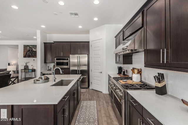 9922 E Thunderbolt Ave, Mesa, AZ 85212 - kitchen featuring a sink, high end appliances, under cabinet range hood, light countertops, and recessed lighting