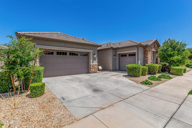 9922 E Thunderbolt Ave, Mesa, AZ 85212 - prairie-style home with stone siding, stucco siding, an attached garage, and a tiled roof
