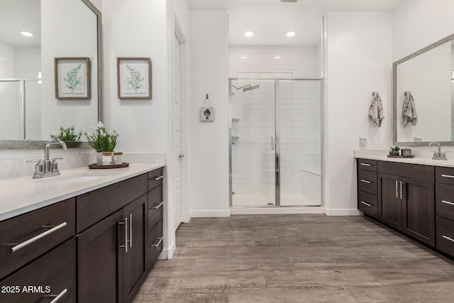 9922 E Thunderbolt Ave, Mesa, AZ 85212 - full bathroom featuring a stall shower, two vanities, baseboards, wood finished floors, and recessed lighting