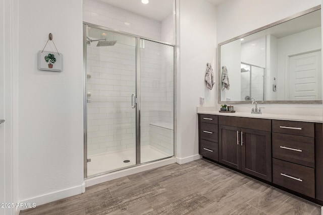 9922 E Thunderbolt Ave, Mesa, AZ 85212 - bathroom with vanity, a shower stall, wood finished floors, baseboards, and recessed lighting