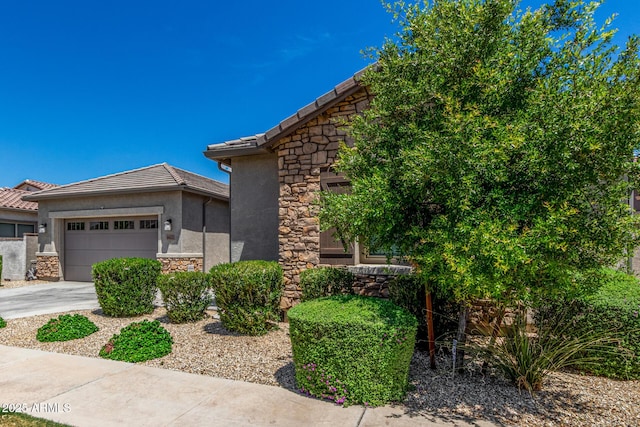 9922 E Thunderbolt Ave, Mesa, AZ 85212 - view of front of property with stone siding, a garage, stucco siding, driveway, and a tile roof