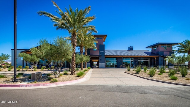9922 E Thunderbolt Ave, Mesa, AZ 85212 - view of front facade featuring a chimney, metal roof, and a standing seam roof