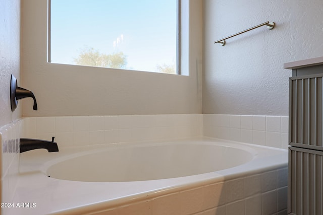 bathroom featuring tiled tub