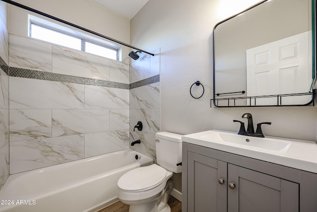 full bathroom with toilet, tiled shower / bath, vanity, and wood-type flooring