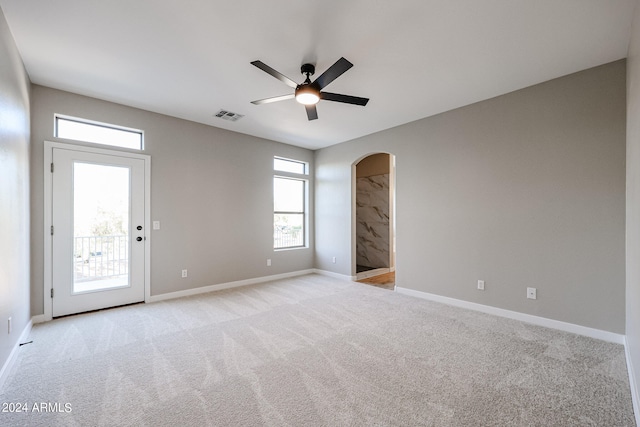 carpeted empty room featuring ceiling fan