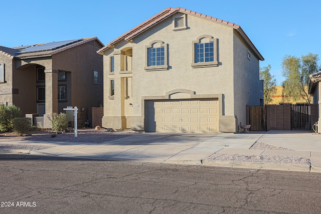 mediterranean / spanish house featuring central air condition unit and a garage