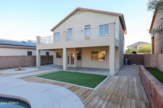 back of property featuring a patio, central AC unit, and a balcony