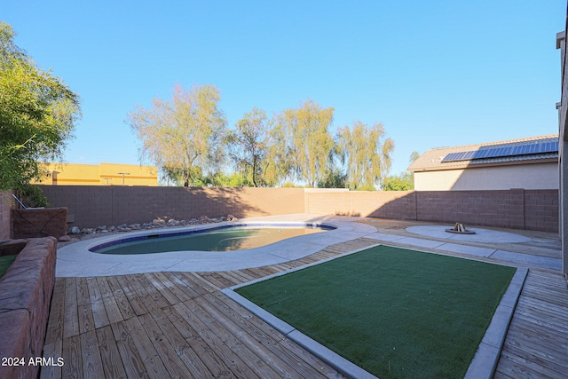 view of pool with a wooden deck and a patio