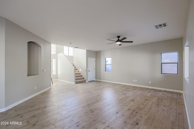 unfurnished room featuring light hardwood / wood-style floors, a healthy amount of sunlight, and ceiling fan