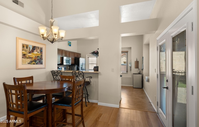 1910 E Citation Ln, Tempe, AZ 85284 - dining area with a chandelier, light wood-style floors, and baseboards