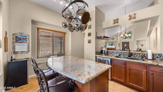 1910 E Citation Ln, Tempe, AZ 85284 - kitchen featuring a chandelier, light tile patterned flooring, a sink, and brown cabinetry