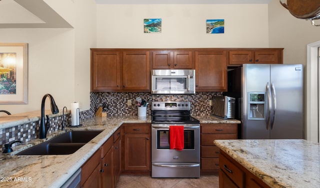 1910 E Citation Ln, Tempe, AZ 85284 - kitchen featuring appliances with stainless steel finishes, a sink, backsplash, and brown cabinets